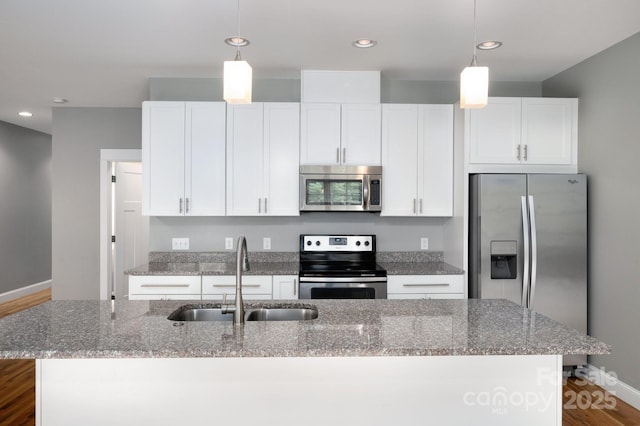 200 N Skyloft Dr Unit 2, Asheville, NC 28801 - kitchen featuring appliances with stainless steel finishes, a sink, a kitchen island with sink, baseboards, and white cabinets