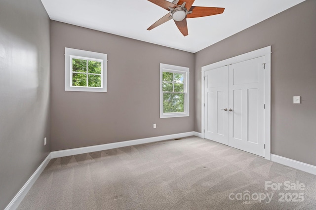 200 N Skyloft Dr Unit 2, Asheville, NC 28801 - unfurnished bedroom with multiple windows, light colored carpet, and baseboards