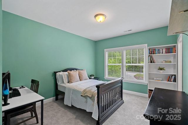 bedroom featuring baseboards, carpet flooring, and an office area