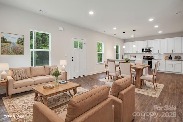 746 Shasta St NW, Concord, NC 28027 - living room featuring dark wood-style flooring, healthy amount of natural light, recessed lighting, and baseboards