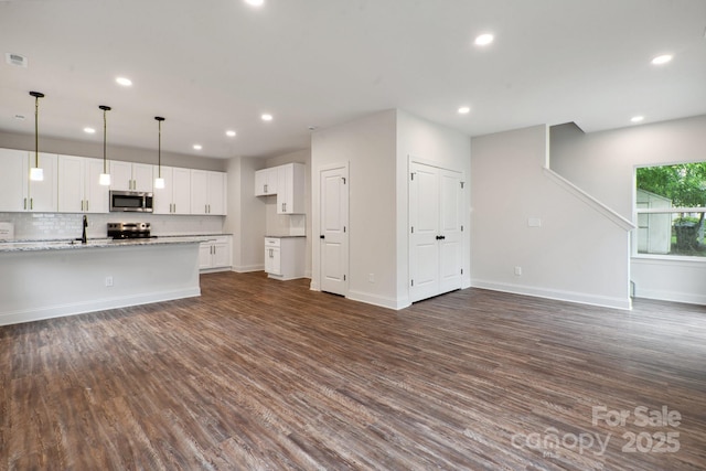 746 Shasta St NW, Concord, NC 28027 - unfurnished living room with recessed lighting, dark wood-style floors, a sink, and baseboards