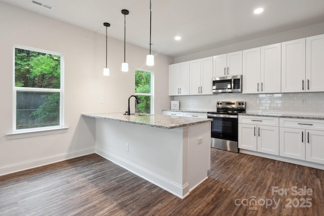 746 Shasta St NW, Concord, NC 28027 - kitchen with stainless steel appliances, tasteful backsplash, dark wood-type flooring, baseboards, and white cabinets