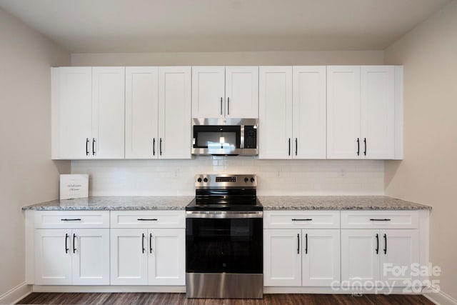 746 Shasta St NW, Concord, NC 28027 - kitchen featuring appliances with stainless steel finishes, white cabinetry, and light stone countertops