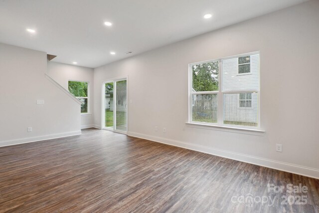 746 Shasta St NW, Concord, NC 28027 - empty room featuring plenty of natural light, dark wood-type flooring, recessed lighting, and baseboards
