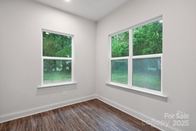 746 Shasta St NW, Concord, NC 28027 - empty room featuring baseboards, dark wood-type flooring, and healthy amount of natural light