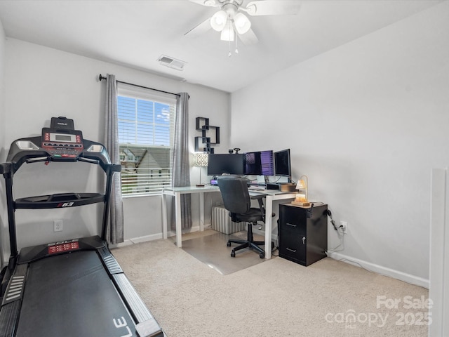 office area featuring a ceiling fan, baseboards, carpet, and radiator heating unit