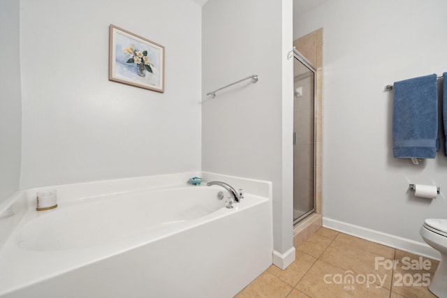 full bath featuring tile patterned flooring, a shower stall, toilet, a garden tub, and baseboards