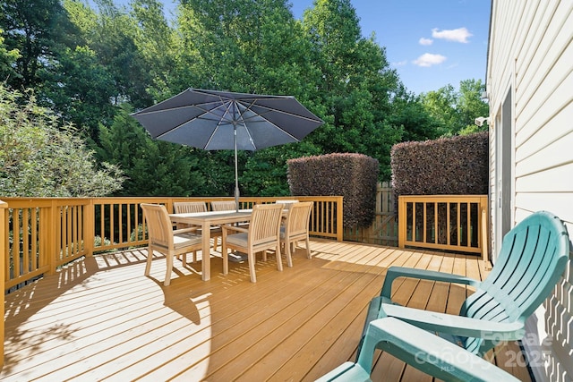wooden terrace featuring outdoor dining space