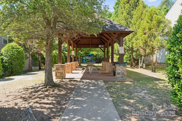 view of home's community with a gazebo and fence