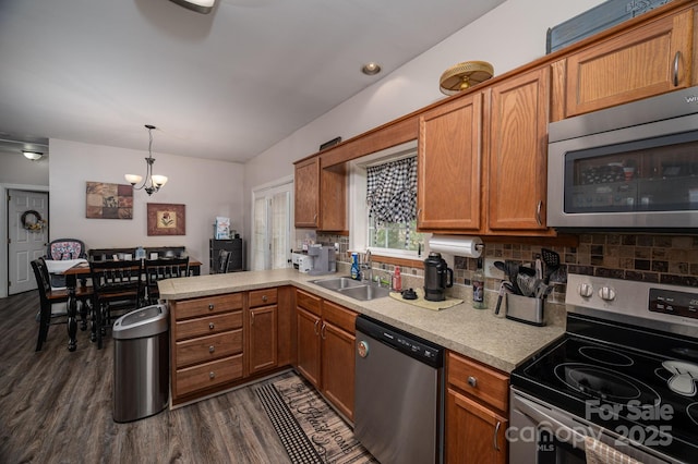167 Brown Watterson Rd, Cherryville, NC 28021 - kitchen featuring appliances with stainless steel finishes, a sink, a chandelier, dark wood-type flooring, and light countertops