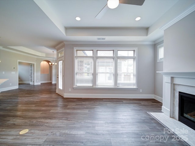 405 Newstyle Way, Gastonia, NC 28056 - unfurnished living room featuring a raised ceiling, ceiling fan, a premium fireplace, dark wood-style floors, and crown molding