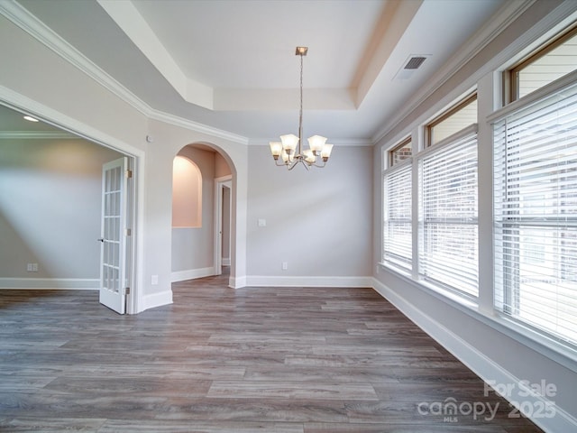 405 Newstyle Way, Gastonia, NC 28056 - unfurnished dining area featuring a tray ceiling, arched walkways, a chandelier, wood finished floors, and baseboards