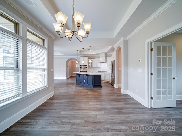 405 Newstyle Way, Gastonia, NC 28056 - kitchen with freestanding refrigerator, arched walkways, a chandelier, white cabinetry, and custom exhaust hood