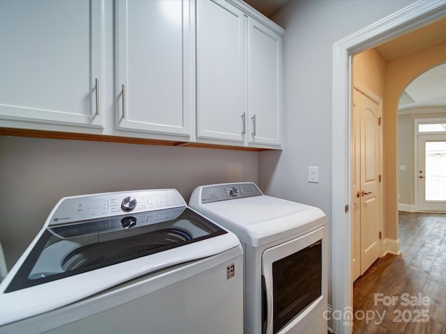 405 Newstyle Way, Gastonia, NC 28056 - washroom featuring washer and dryer, arched walkways, cabinet space, and wood finished floors