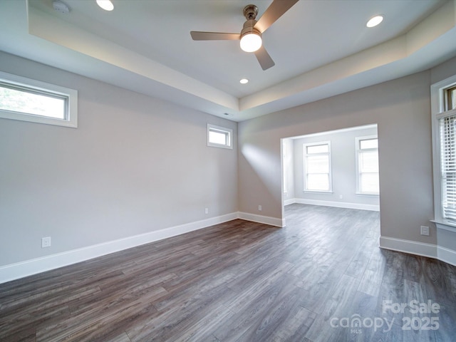 405 Newstyle Way, Gastonia, NC 28056 - unfurnished room featuring a tray ceiling, ceiling fan, dark wood-style flooring, plenty of natural light, and recessed lighting