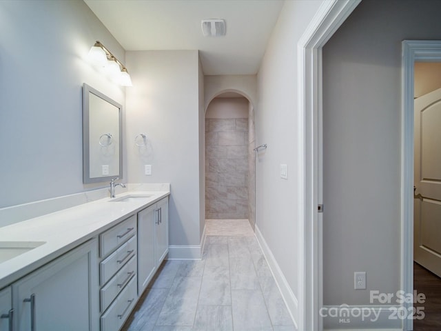 405 Newstyle Way, Gastonia, NC 28056 - bathroom featuring baseboards, double vanity, marble finish flooring, and a tile shower