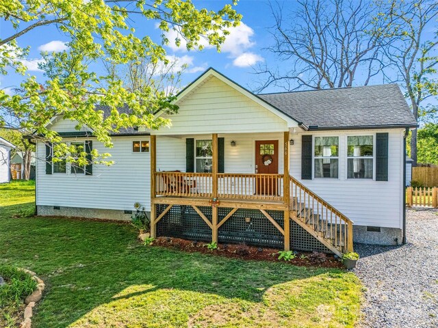 view of front facade with crawl space, covered porch, and a shingled roof