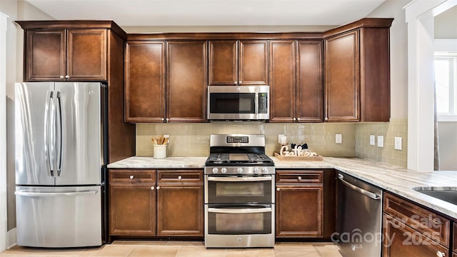 7324 Jolly Brook Dr, Charlotte, NC 28215 - kitchen with stainless steel appliances, tasteful backsplash, and light stone counters