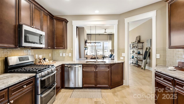 7324 Jolly Brook Dr, Charlotte, NC 28215 - kitchen with appliances with stainless steel finishes, ceiling fan, light wood-type flooring, a sink, and recessed lighting