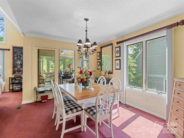 dining room featuring carpet, baseboards, a chandelier, a textured ceiling, and crown molding