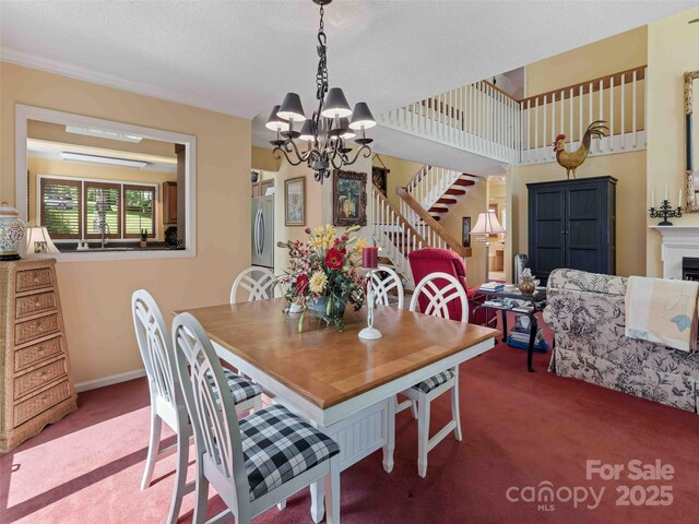 carpeted dining room with a chandelier and stairs