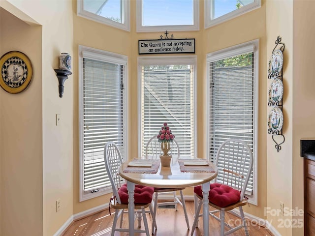 dining room with baseboards and wood finished floors