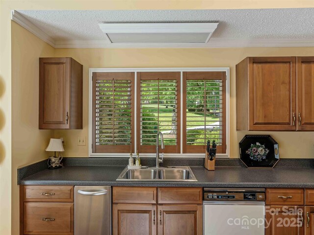 kitchen featuring a sink, dishwasher, a textured ceiling, dark countertops, and crown molding