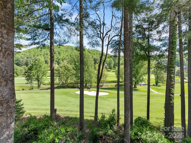 view of home's community with a lawn and golf course view