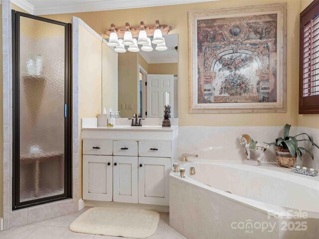bathroom with ornamental molding, a shower stall, a garden tub, vanity, and tile patterned floors