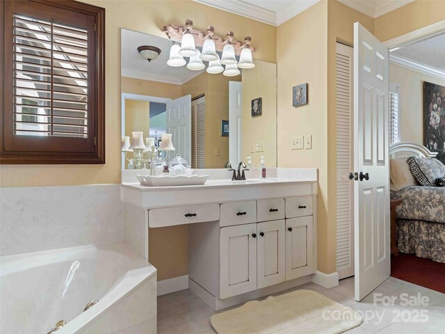 ensuite bathroom with tile patterned flooring, ornamental molding, a bath, vanity, and baseboards