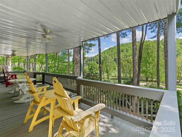 wooden terrace with a ceiling fan