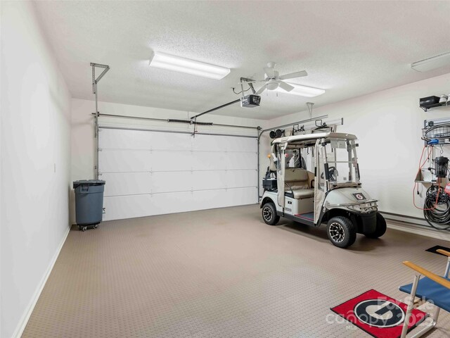 garage with a garage door opener and ceiling fan