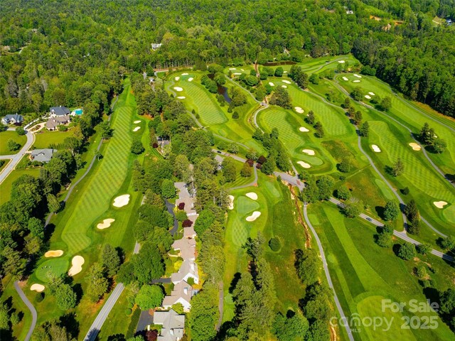 aerial view of a heavily wooded area and a local golf course