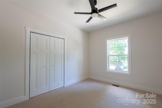 7426 Hambright Rd, Huntersville, NC 28078 - unfurnished bedroom featuring light carpet, baseboards, a ceiling fan, and a closet