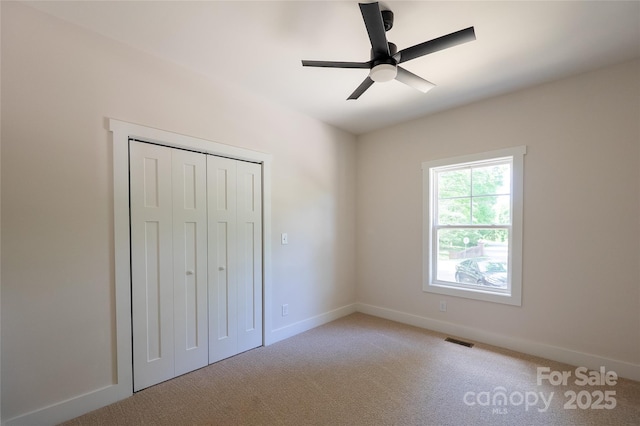 7426 Hambright Rd, Huntersville, NC 28078 - unfurnished bedroom with light carpet, baseboards, a closet, and ceiling fan