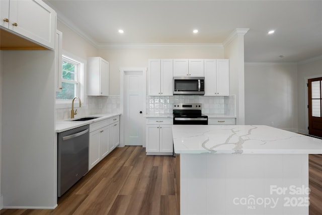 7426 Hambright Rd, Huntersville, NC 28078 - kitchen with stainless steel appliances, a sink, wood finished floors, white cabinets, and tasteful backsplash