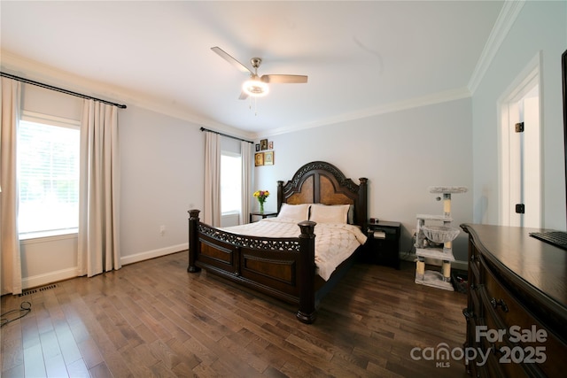 bedroom featuring crown molding, multiple windows, dark wood-style flooring, baseboards, and a ceiling fan