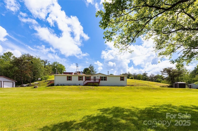 283 Grandview Dr Unit 1, Marshall, NC 28753 - back of house with a lawn, an outbuilding, a garage, and a wooden deck