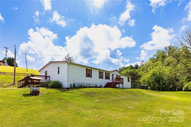 283 Grandview Dr Unit 1, Marshall, NC 28753 - back of property featuring a lawn and a wooden deck
