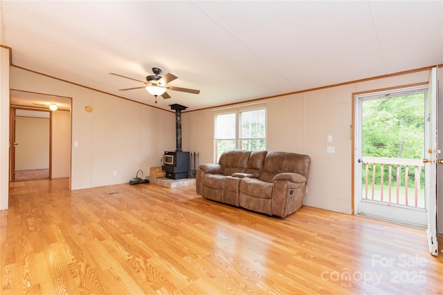 283 Grandview Dr Unit 1, Marshall, NC 28753 - living room featuring crown molding, a wood stove, light wood-style floors, ceiling fan, and vaulted ceiling