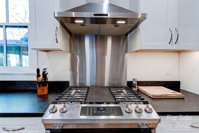 12 Waverly Rd, Asheville, NC 28803 - kitchen featuring dark countertops, stainless steel range with gas stovetop, white cabinetry, and exhaust hood