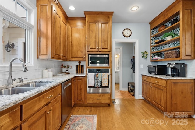 216 Saint Andrews Blvd, Campobello, SC 29322 - kitchen with appliances with stainless steel finishes, open shelves, tasteful backsplash, brown cabinets, and light stone counters