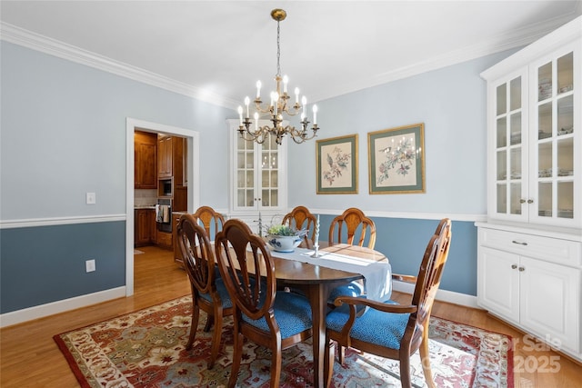 216 Saint Andrews Blvd, Campobello, SC 29322 - dining area with a chandelier, light wood finished floors, and crown molding