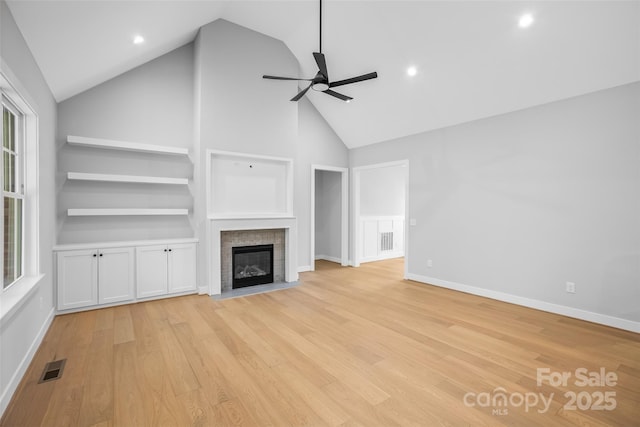 149 Beauchamp Oaks Ct, Advance, NC 27006 - unfurnished living room with ceiling fan, light wood finished floors, a brick fireplace, high vaulted ceiling, and healthy amount of natural light