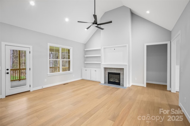 149 Beauchamp Oaks Ct, Advance, NC 27006 - unfurnished living room featuring high vaulted ceiling, ceiling fan, light wood-type flooring, baseboards, and a fireplace with flush hearth