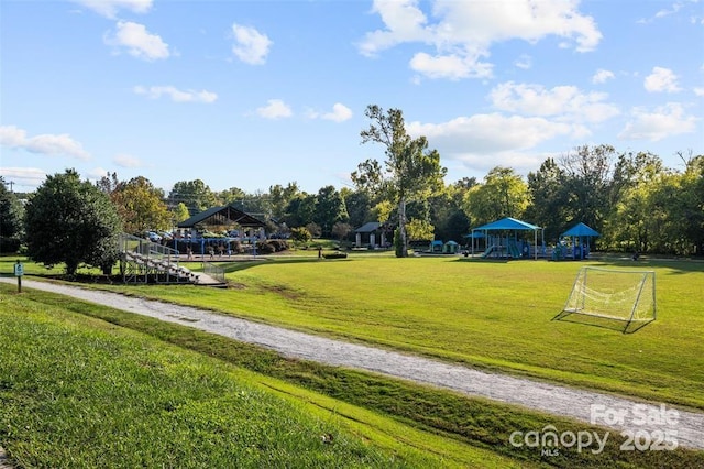 view of home's community with a sport area, a gazebo, and view of scattered trees