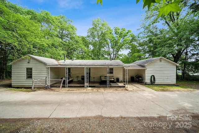 1917 Tom Sadler Rd, Charlotte, NC 28214 - back of house with an attached carport, concrete driveway, and covered porch