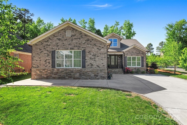 view of front facade with a front lawn and brick siding