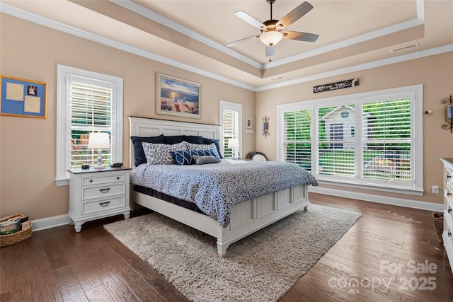 bedroom with a raised ceiling, baseboards, crown molding, dark wood finished floors, and ceiling fan
