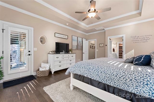 bedroom with a raised ceiling, dark wood-style floors, ornamental molding, baseboards, and a ceiling fan